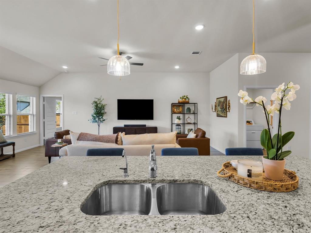 13141 Yellowstone Way Providence Village, TX 76227 - Photo 16 of 40 a living room with furniture kitchen view and a chandelier