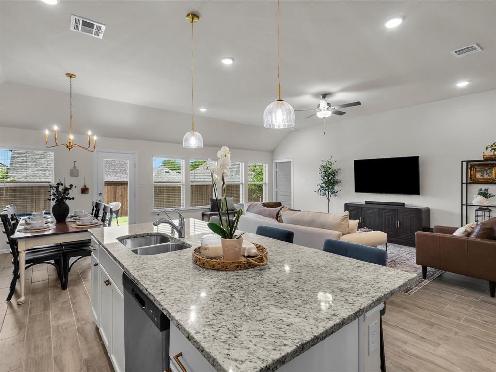 13141 Yellowstone Way Providence Village, TX 76227 - Photo 17 of 40 a view of living room kitchen with granite countertop living room dining room and couches