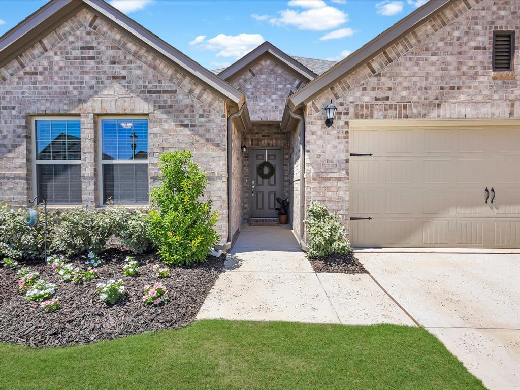 13141 Yellowstone Way Providence Village, TX 76227 - Photo 2 of 40 a front view of a house with garden