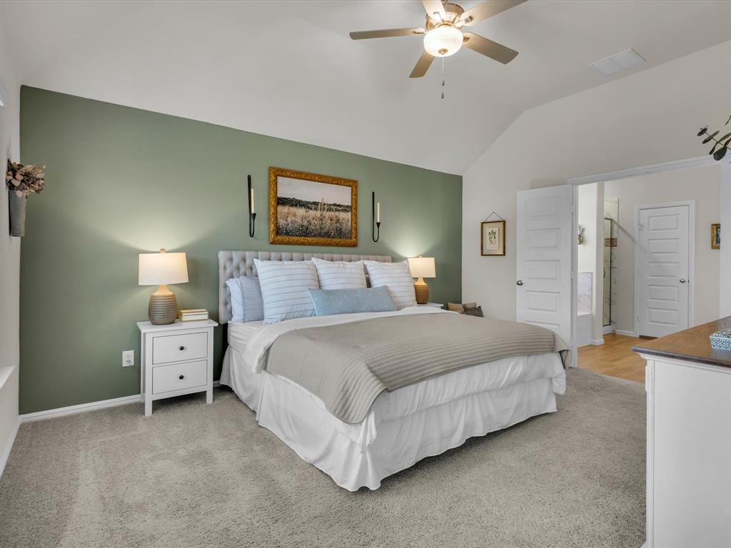 13141 Yellowstone Way Providence Village, TX 76227 - Photo 21 of 40 a spacious bedroom with a bed and a chandelier