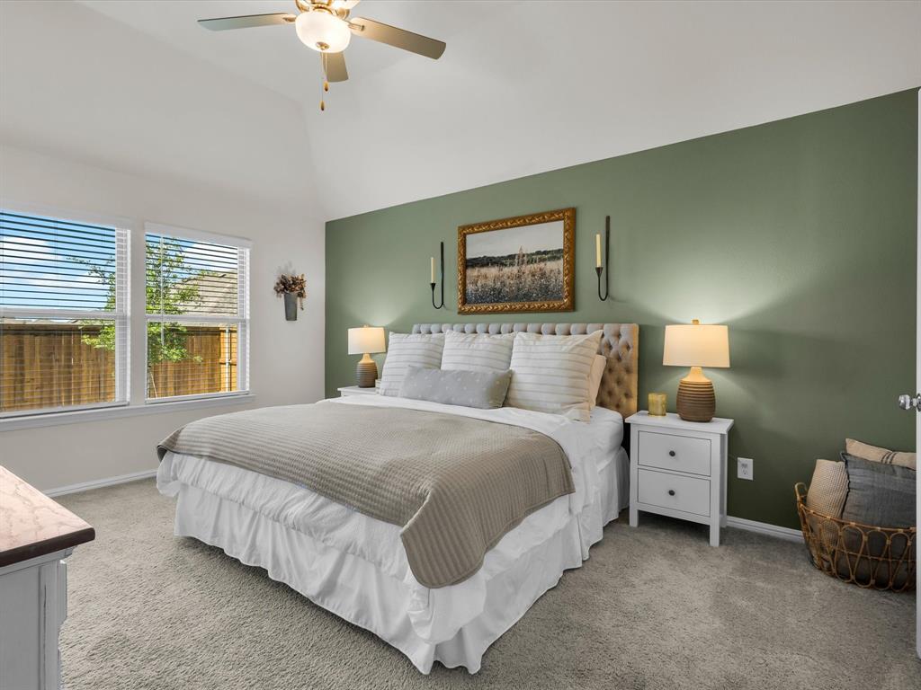 13141 Yellowstone Way Providence Village, TX 76227 - Photo 22 of 40 a bedroom with a bed and a chandelier