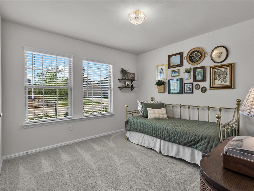 13141 Yellowstone Way Providence Village, TX 76227 - Photo 27 of 40 a bedroom with a bed and a window