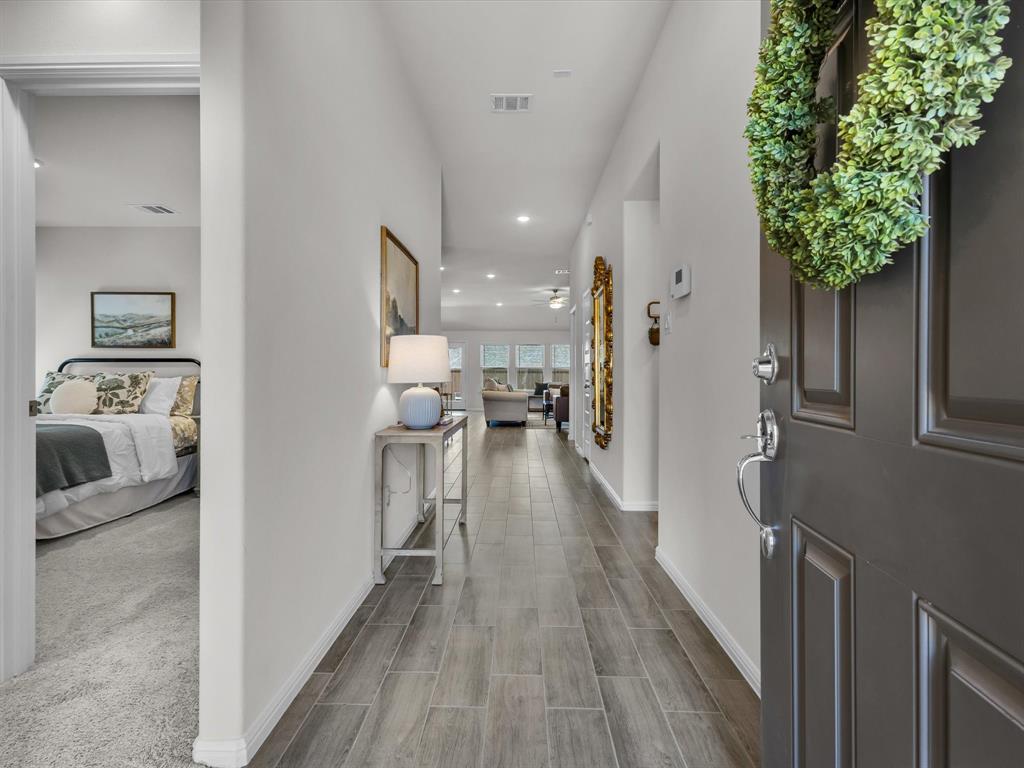 13141 Yellowstone Way Providence Village, TX 76227 - Photo 3 of 40 a view of hallway with furniture and wooden floor