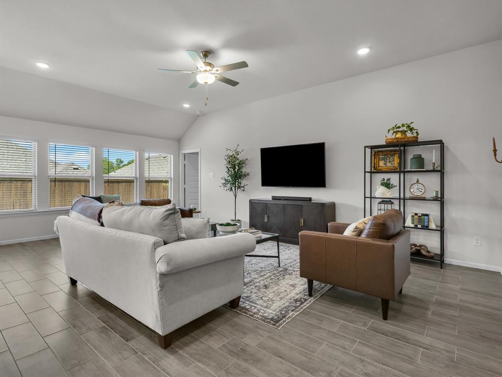 13141 Yellowstone Way Providence Village, TX 76227 - Photo 7 of 40 a living room with furniture and a flat screen tv