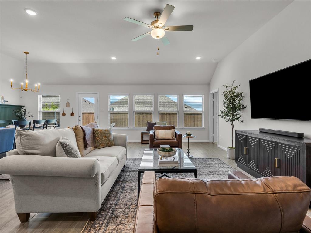 13141 Yellowstone Way Providence Village, TX 76227 - Photo 8 of 40 a living room with fireplace furniture and a flat screen tv