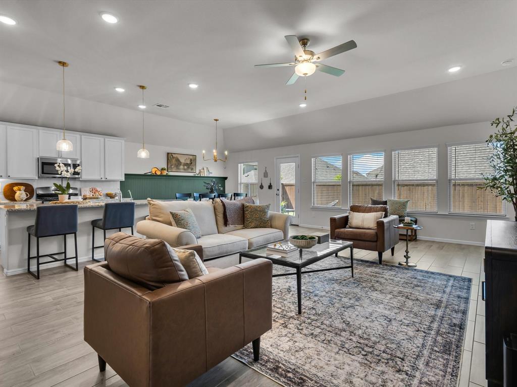13141 Yellowstone Way Providence Village, TX 76227 - Photo 9 of 40 a living room with furniture kitchen view and a chandelier