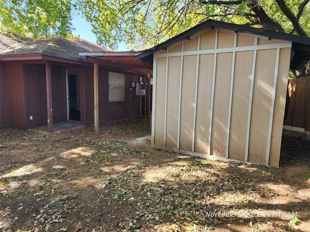 a view of wooden house with a yard