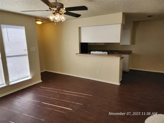 a view of room with window and wooden floor