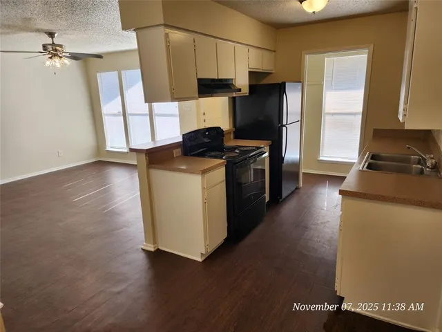 a kitchen with wooden cabinets and a stove top oven