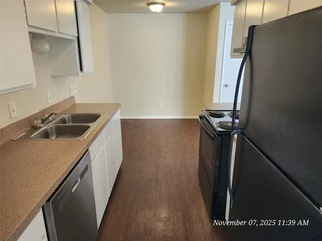 a kitchen with a sink a refrigerator and washer