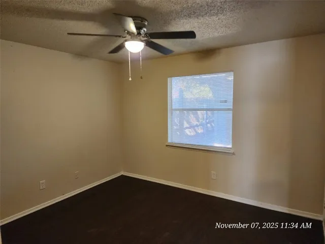 an empty room with a fan