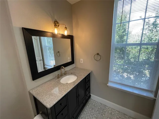 a bathroom with a double vanity sink and a mirror