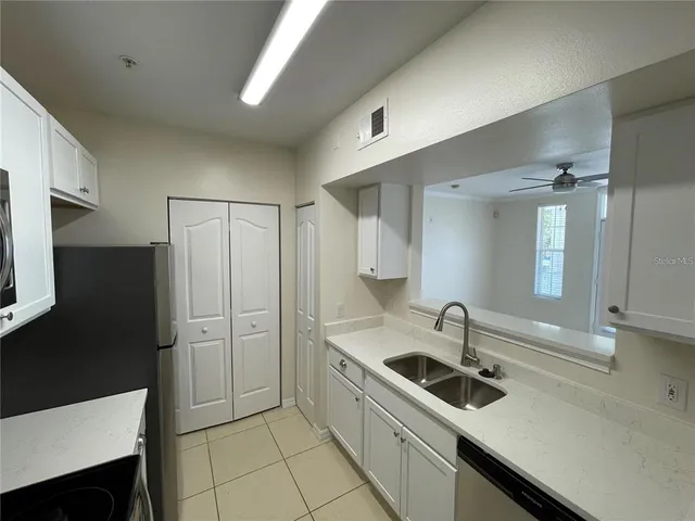 a kitchen with a sink appliances and cabinets