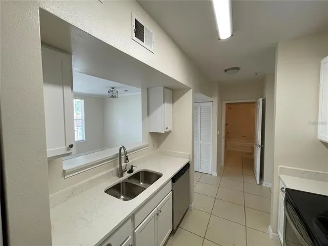 a kitchen with a sink and cabinets