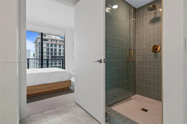 a bathroom with a bathtub and shower