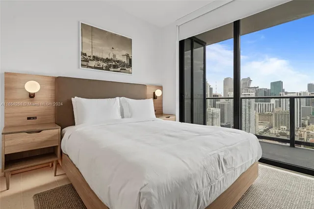 a large white bed in a small room