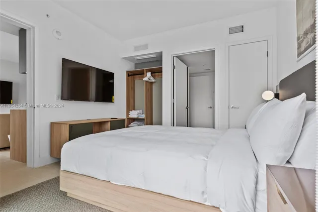 a spacious bathroom with a granite countertop sink a toilet and shower