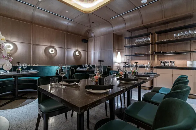 a kitchen with a table chairs stove and cabinets