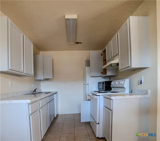 a kitchen with cabinets and a sink