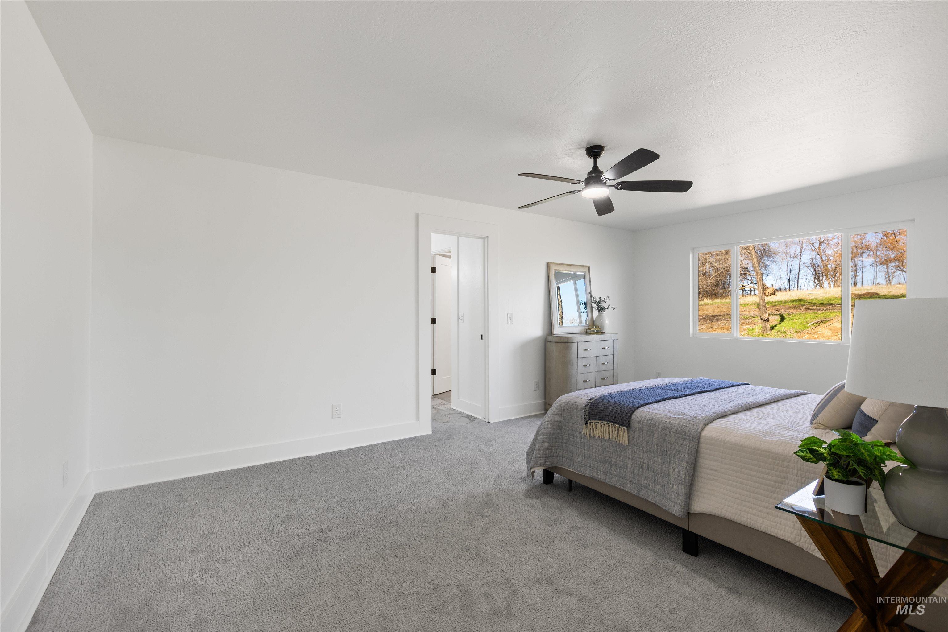29862 Emmett Road Caldwell, ID 83607 - Photo 18 of 44 Bedroom featuring carpet and a ceiling fan