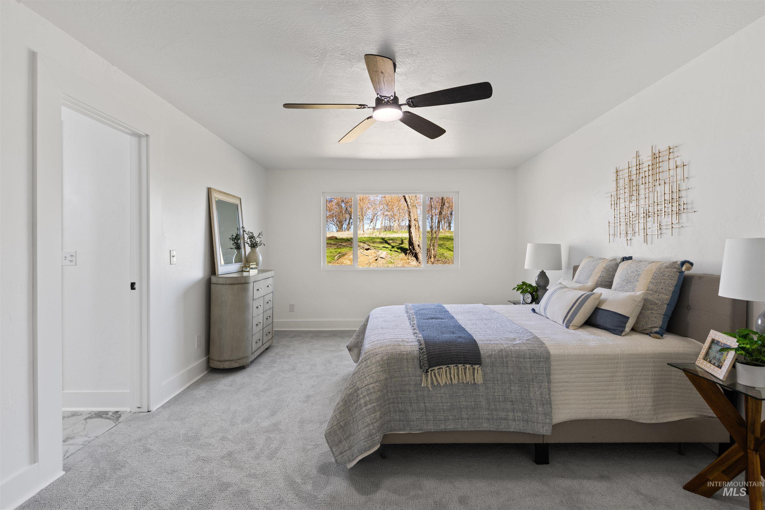 29862 Emmett Road Caldwell, ID 83607 - Photo 19 of 44 Bedroom featuring a ceiling fan and light carpet