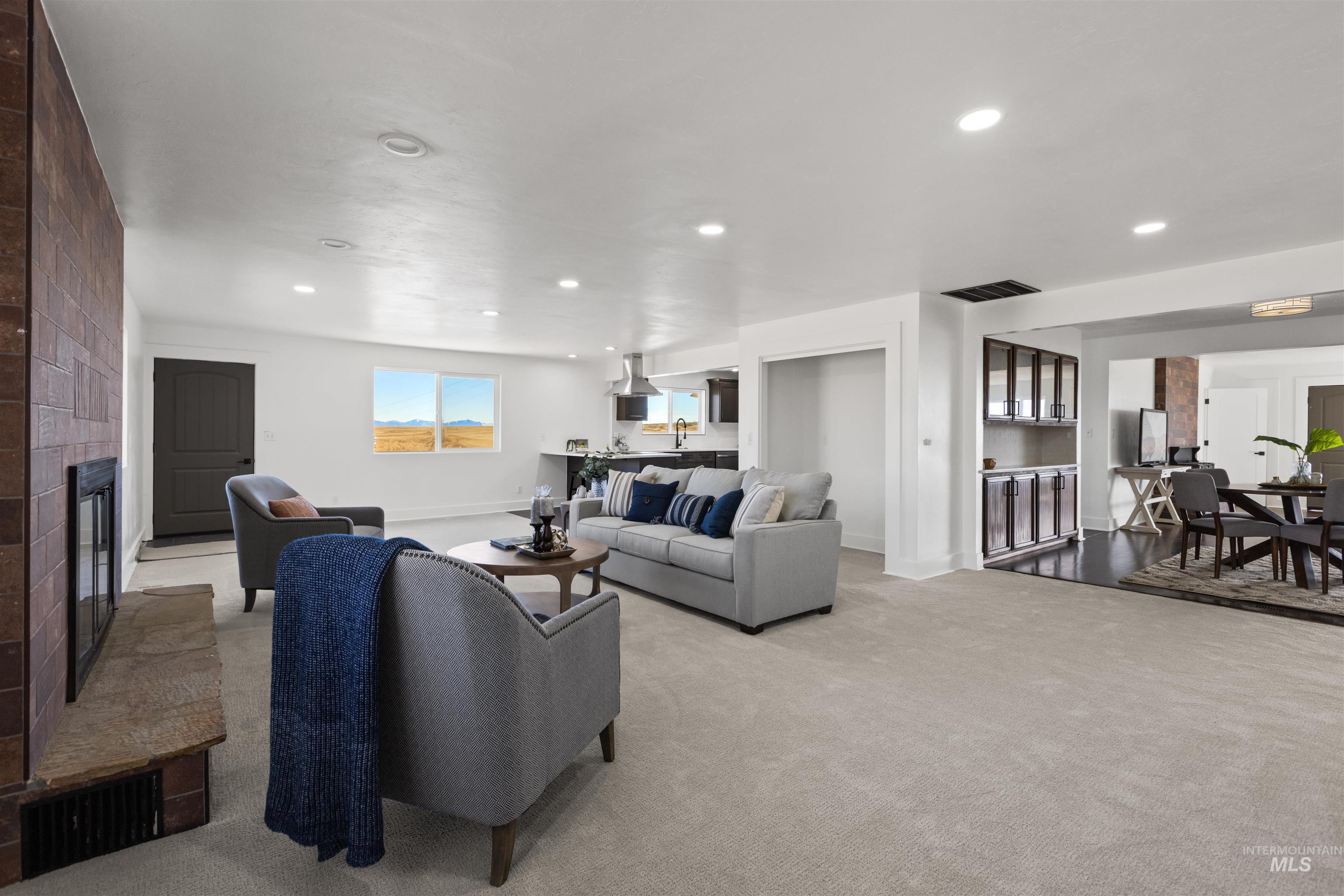 29862 Emmett Road Caldwell, ID 83607 - Photo 26 of 44 Living room with carpet flooring, a large fireplace, and recessed lighting
