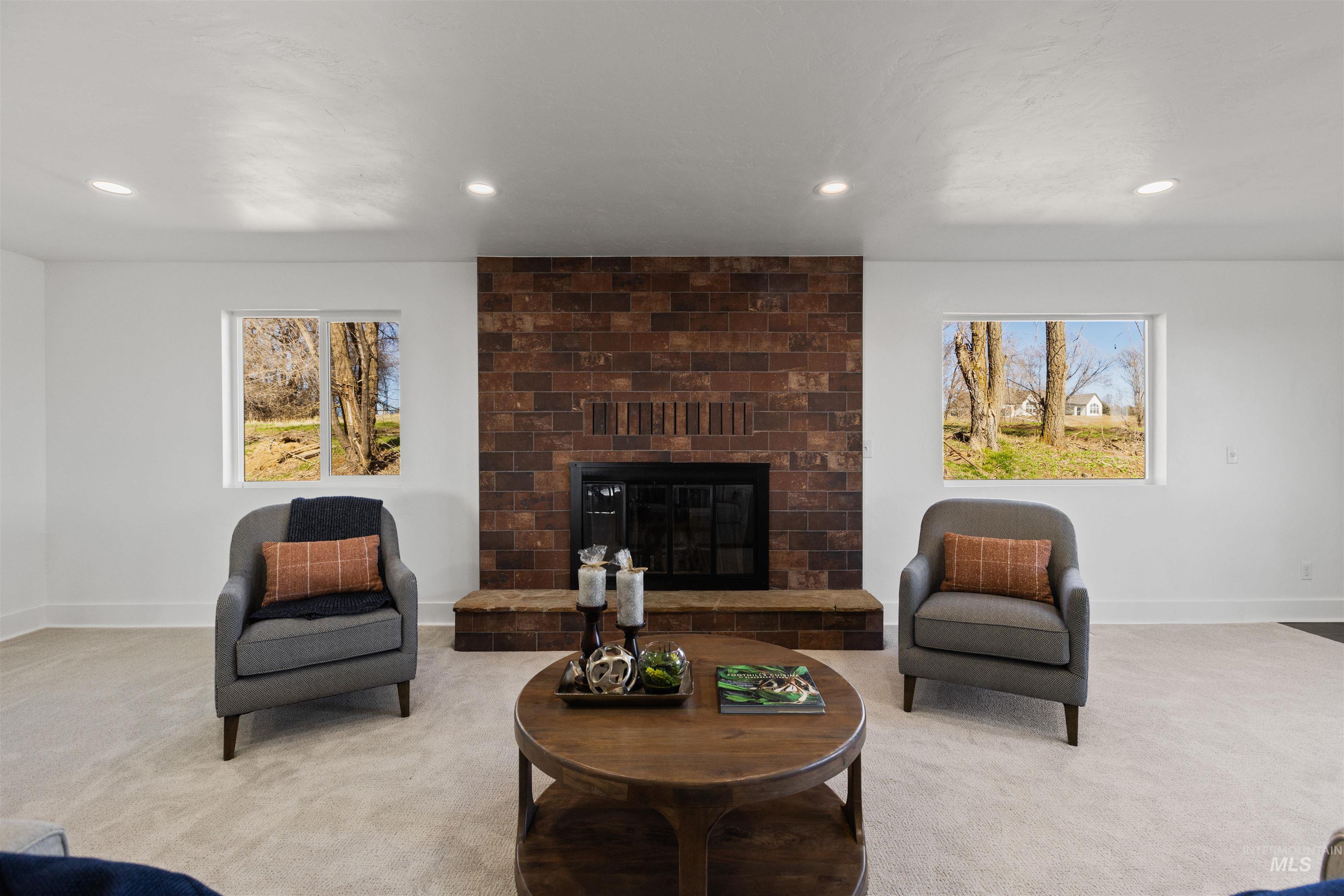 29862 Emmett Road Caldwell, ID 83607 - Photo 27 of 44 Carpeted living area featuring a brick fireplace and recessed lighting