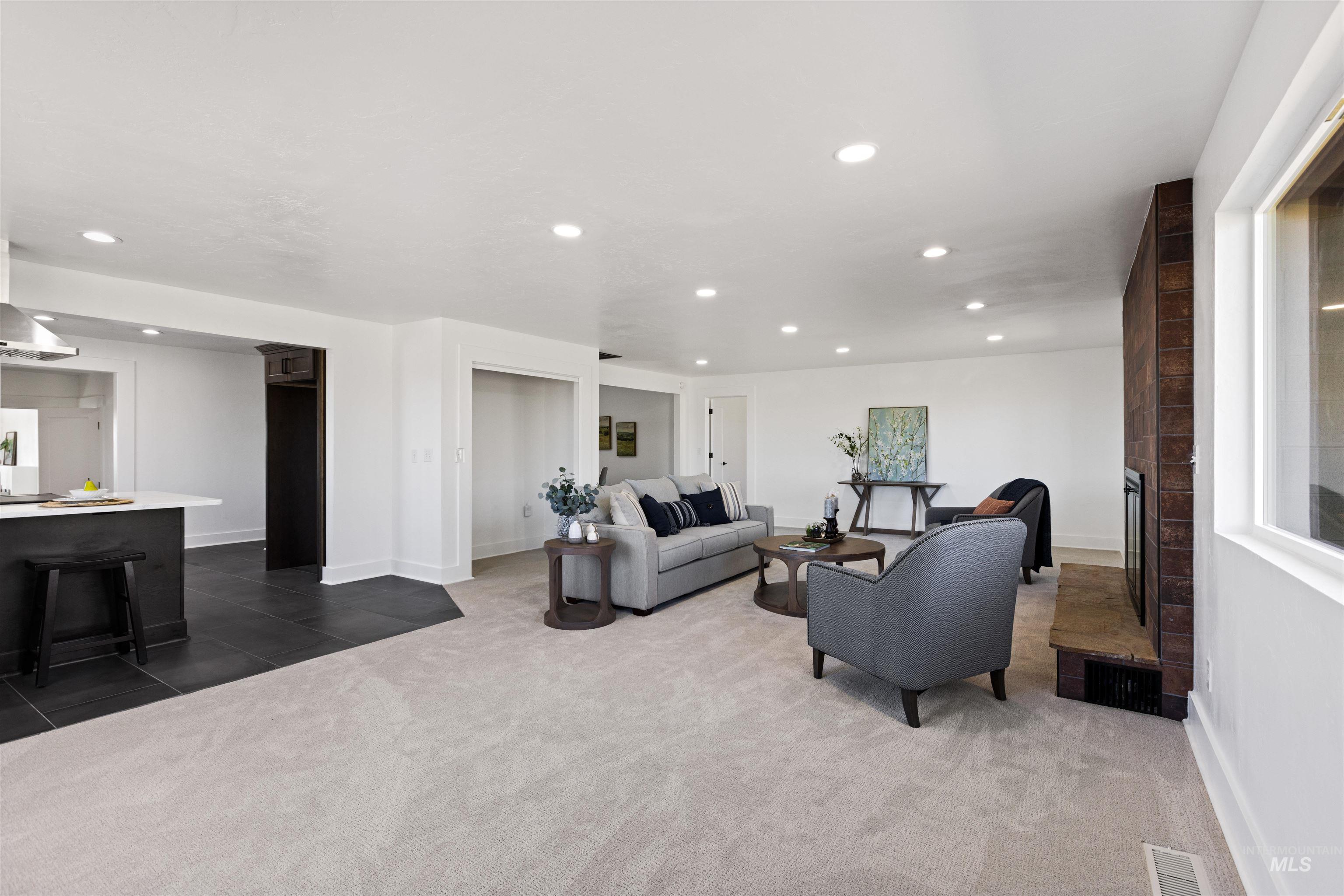 29862 Emmett Road Caldwell, ID 83607 - Photo 28 of 44 Living room featuring dark tile patterned flooring, dark carpet, and recessed lighting