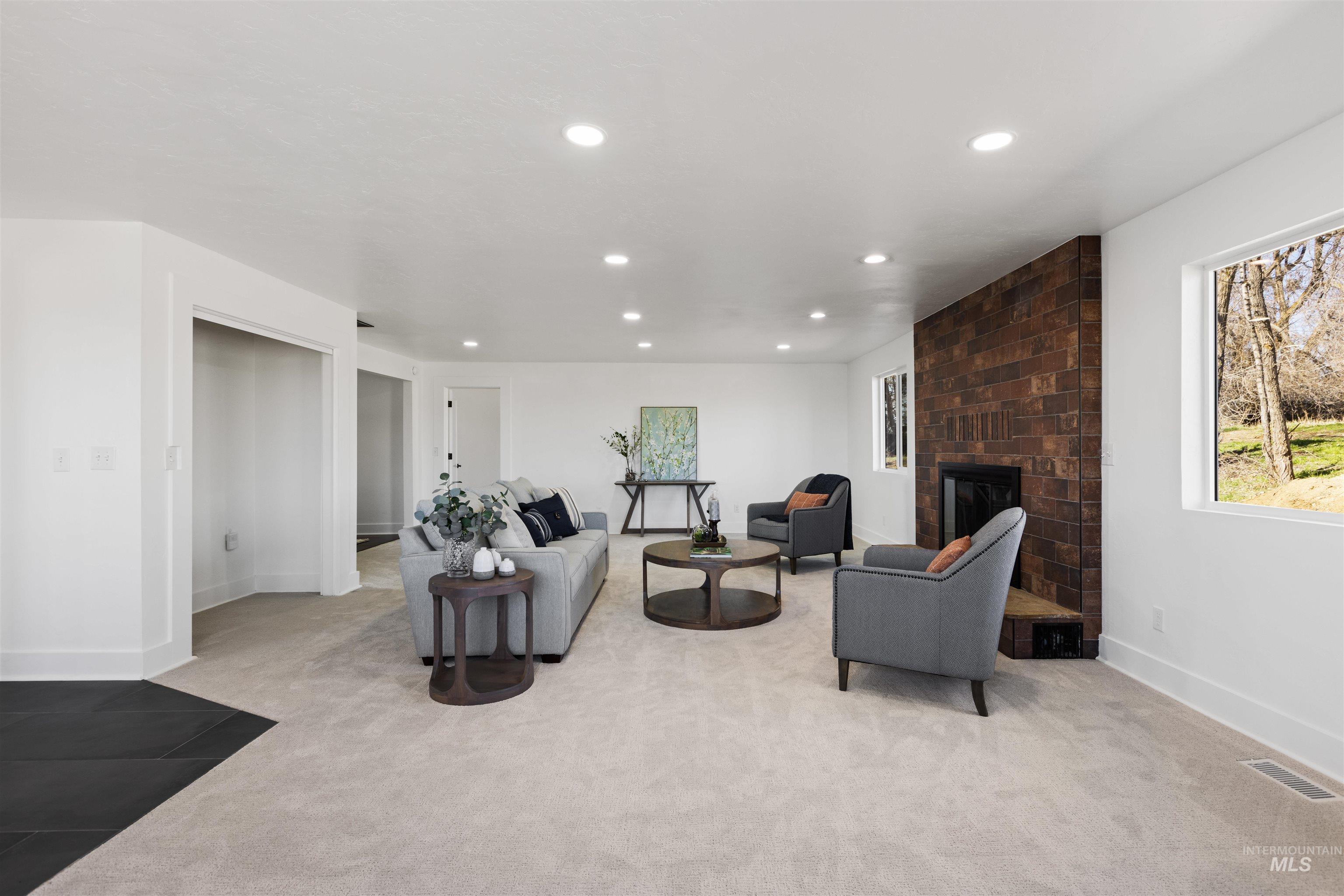 29862 Emmett Road Caldwell, ID 83607 - Photo 29 of 44 Living room featuring light colored carpet, recessed lighting, and a brick fireplace