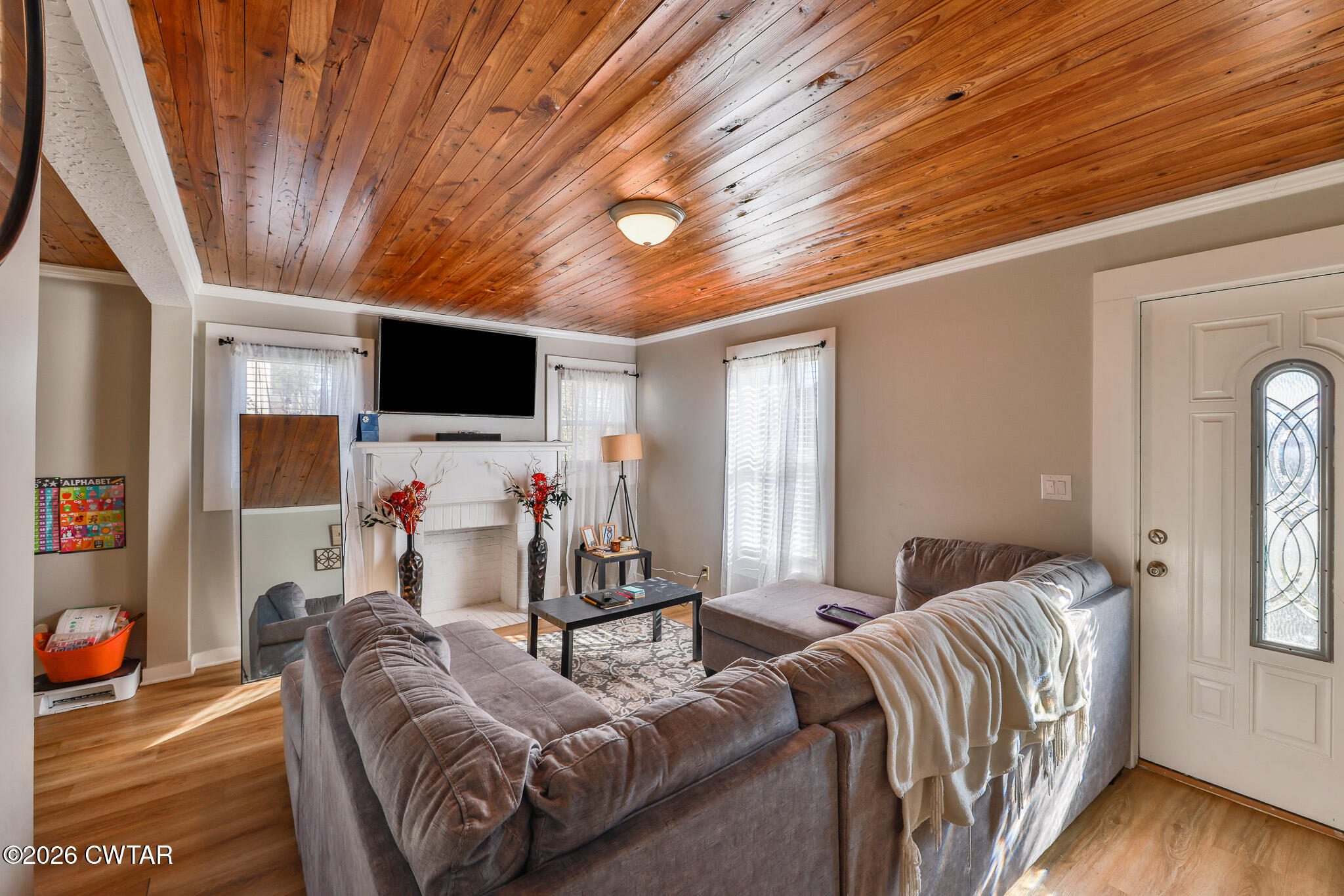 150 West Locust Street Dresden, TN 38225 - Photo 12 of 31 a living room with furniture a flat screen tv and a fireplace