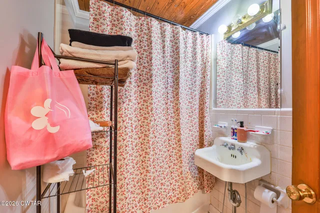 a bathroom with a sink toilet and a mirror