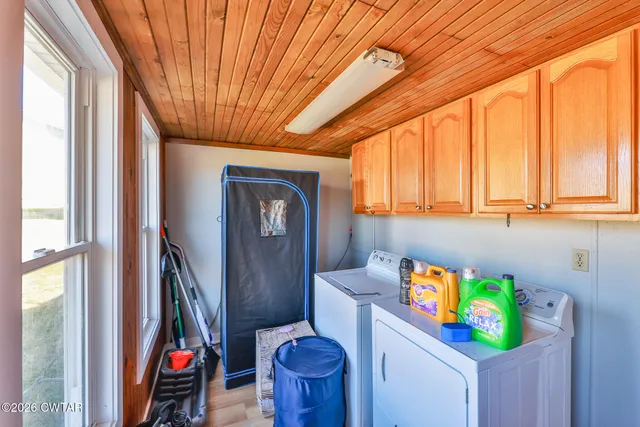 a bathroom with a sink a mirror and next to a window