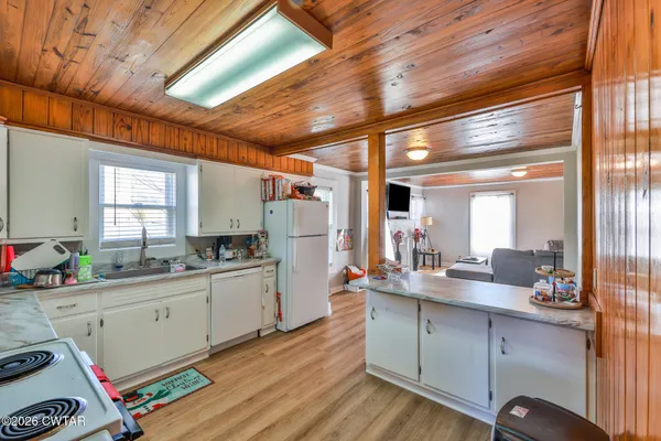 a kitchen with a sink appliances and cabinets