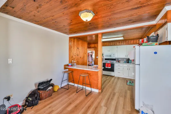 a view of a room with wooden floor and furniture