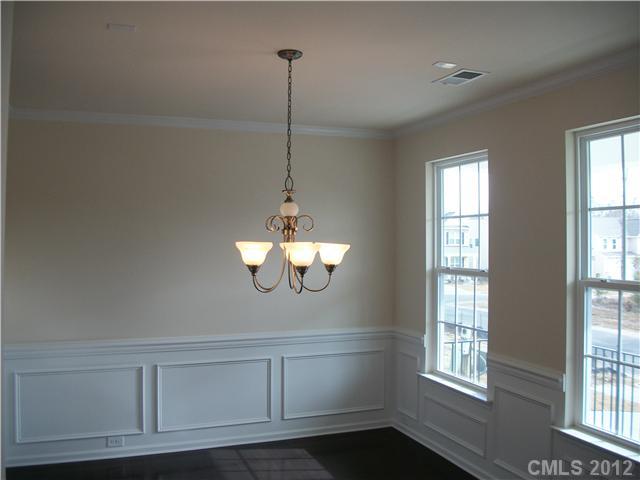 1204 Screech Owl Road Waxhaw, NC 28173 - Photo 3 of 16 a view of a room with cabinet a chandelier and windows