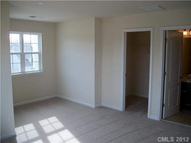 1204 Screech Owl Road Waxhaw, NC 28173 - Photo 8 of 16 an empty room with windows