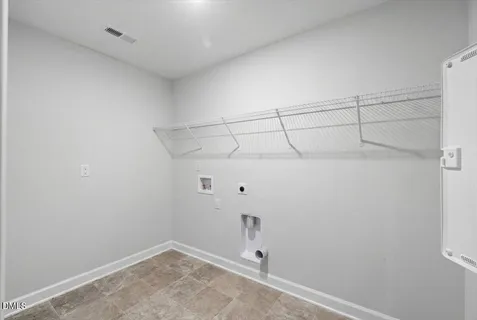an empty room with closet and a ceiling fan