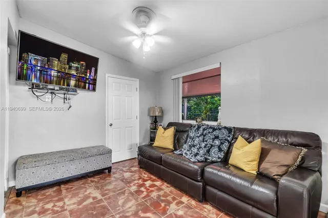 a living room with furniture and a flat screen tv