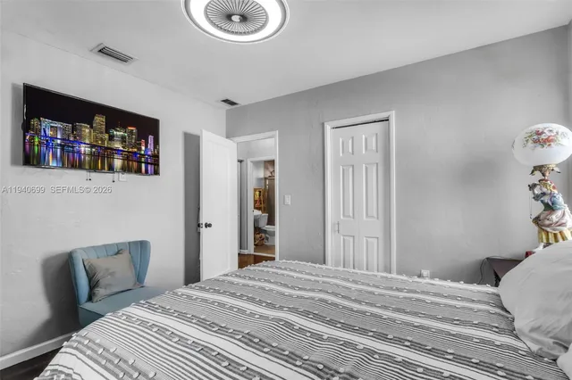 a bedroom with a bed and a large mirror