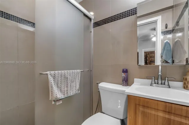 a bathroom with a sink mirror vanity and toilet