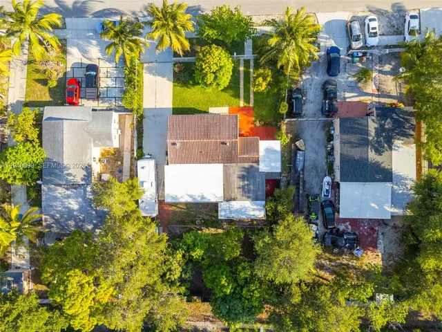 an aerial view of residential houses with outdoor space and swimming pool