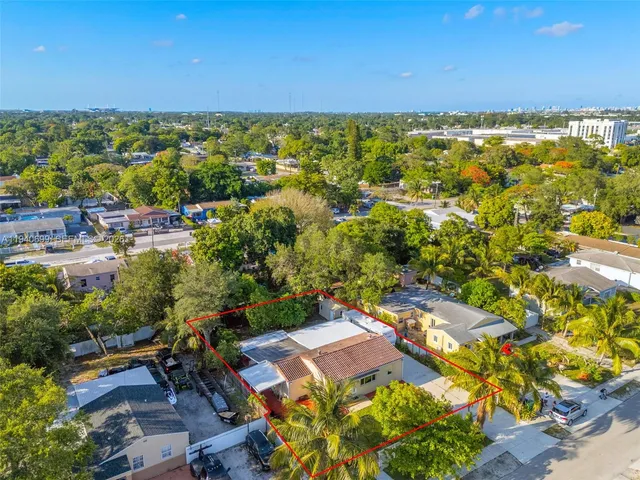 an aerial view of residential houses with outdoor space and swimming pool