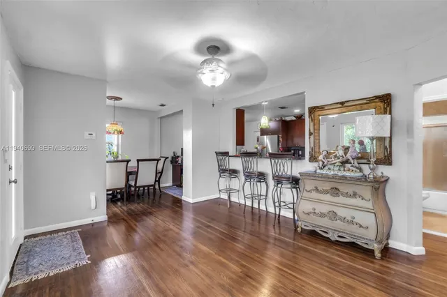 a view of a dining room kitchen with furniture and wooden floor