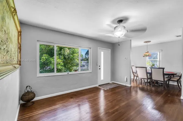 a view of a dining room with furniture window and wooden floor