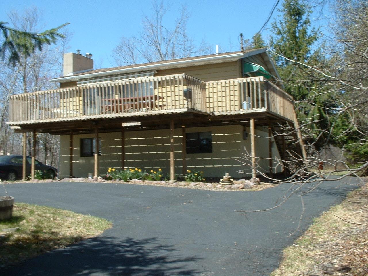 65 Buck Hill Road Blakeslee, PA 18610 - Photo 1 of 16 a front view of a house with a yard