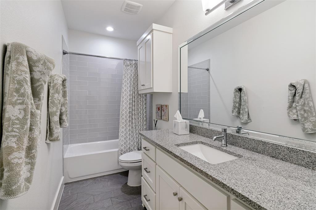 7533 Garonne Street Dallas, TX 75231 - Photo 24 of 32 a bathroom with a granite countertop sink a toilet and shower