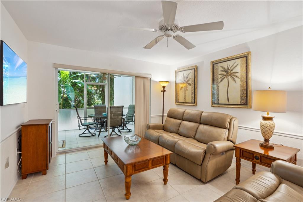 15405 Cedarwood Lane, Unit 2101 Naples, FL 34110 - Photo 1 of 36 a living room with furniture and floor to ceiling windows