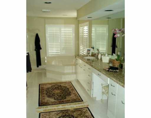 48 Rio Vista Drive Stuart, FL 34996 - Photo 6 of 8 a bathroom with a granite countertop sink a toilet and a shower