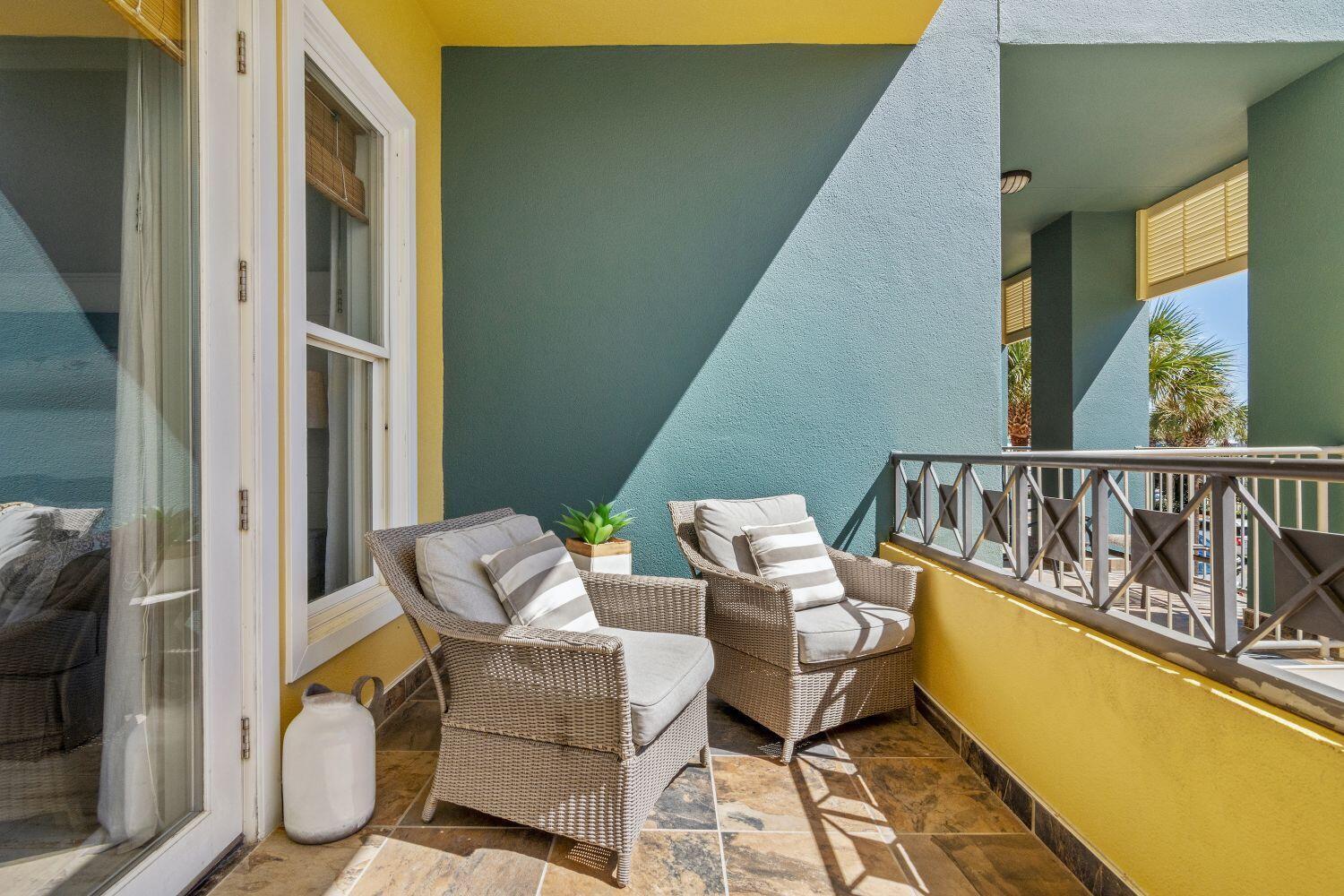 95 Laura Hamilton Boulevard, Unit 209 Santa Rosa Beach, FL 32459 - Photo 24 of 37 a balcony with couple of chairs and a potted plant