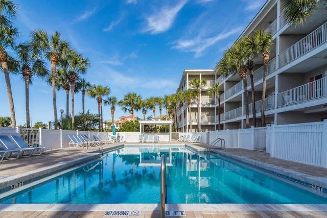 a view of swimming pool with outdoor seating and city view